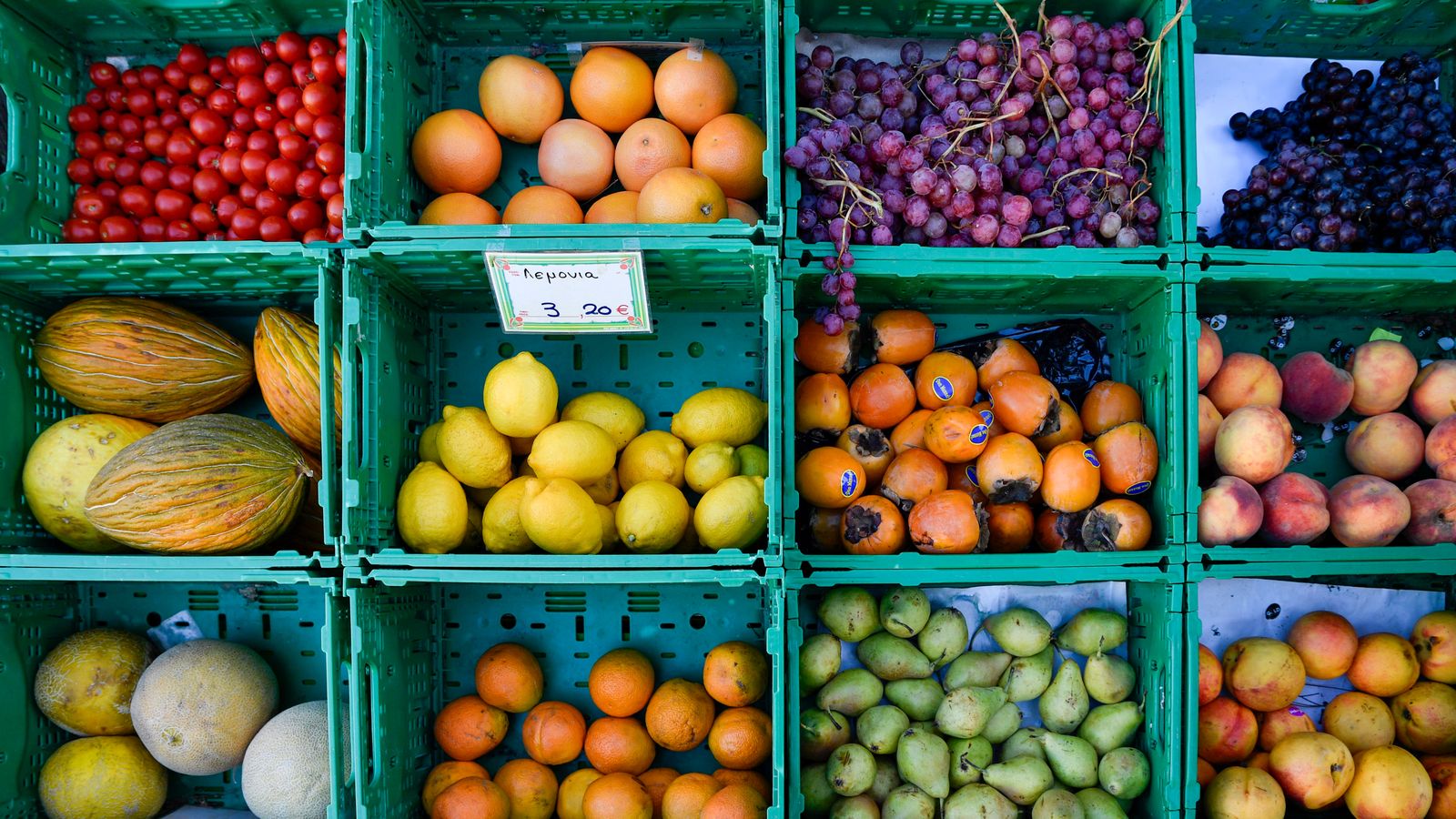 Vibrant fruit display at a greengrocer's market stall